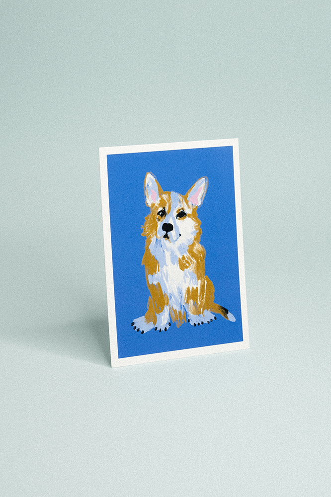 Carte postale fond bleu foncé illustrée d’un corgi mignon assis..